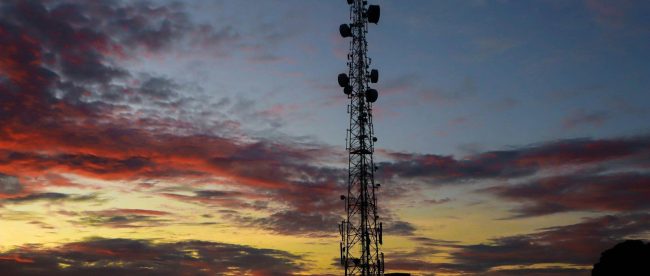 a very tall tower sitting under a cloudy sky